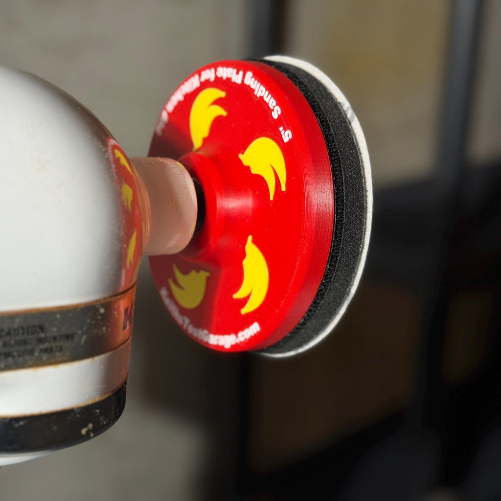 Close-up of the Cherry Red 5 inch sanding plate on the KitchenAid power hub