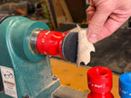 Peeling a 2 inch hook and loop disc off the squishy pad