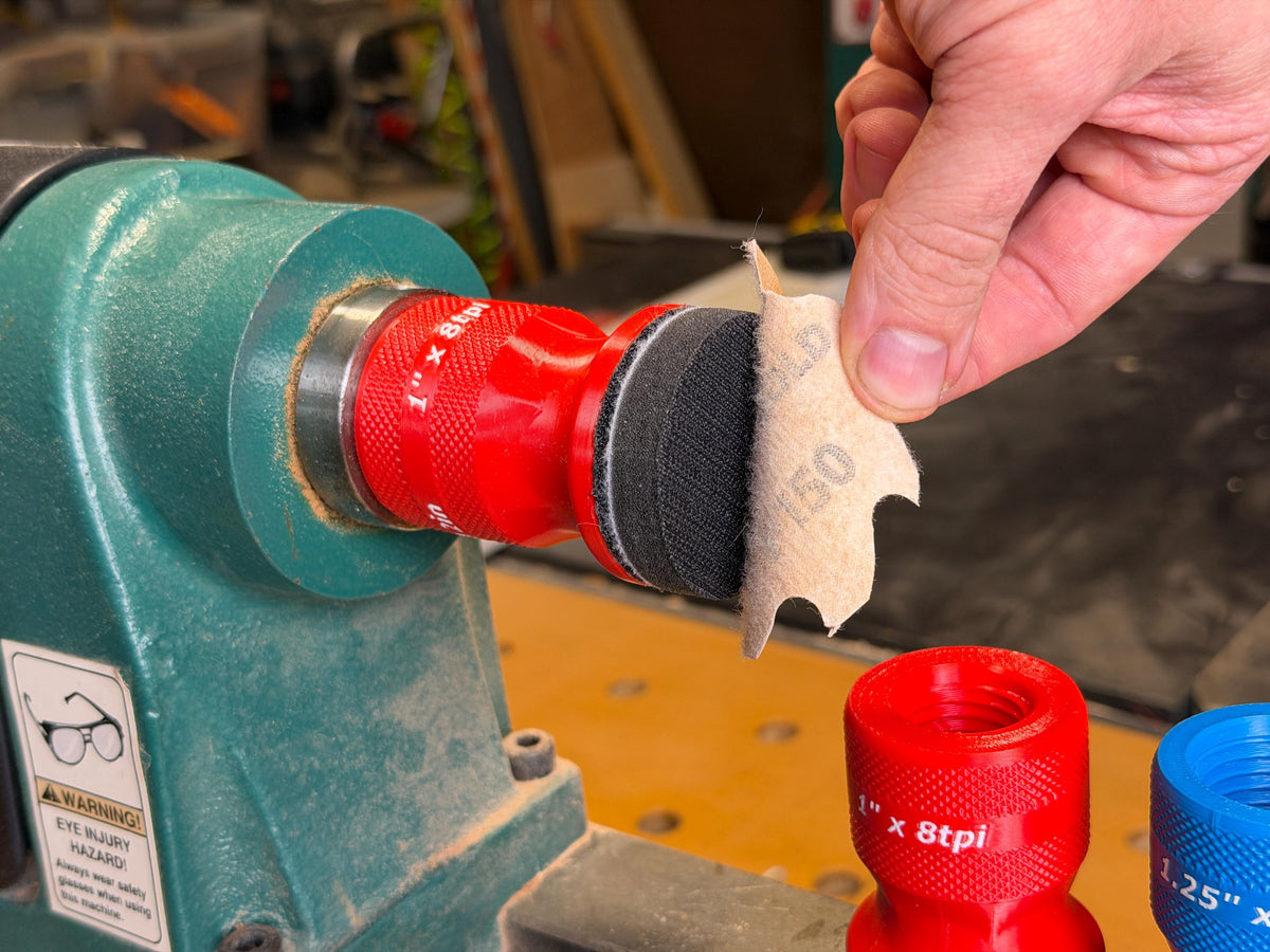 Peeling a 2 inch hook and loop disc off the squishy pad