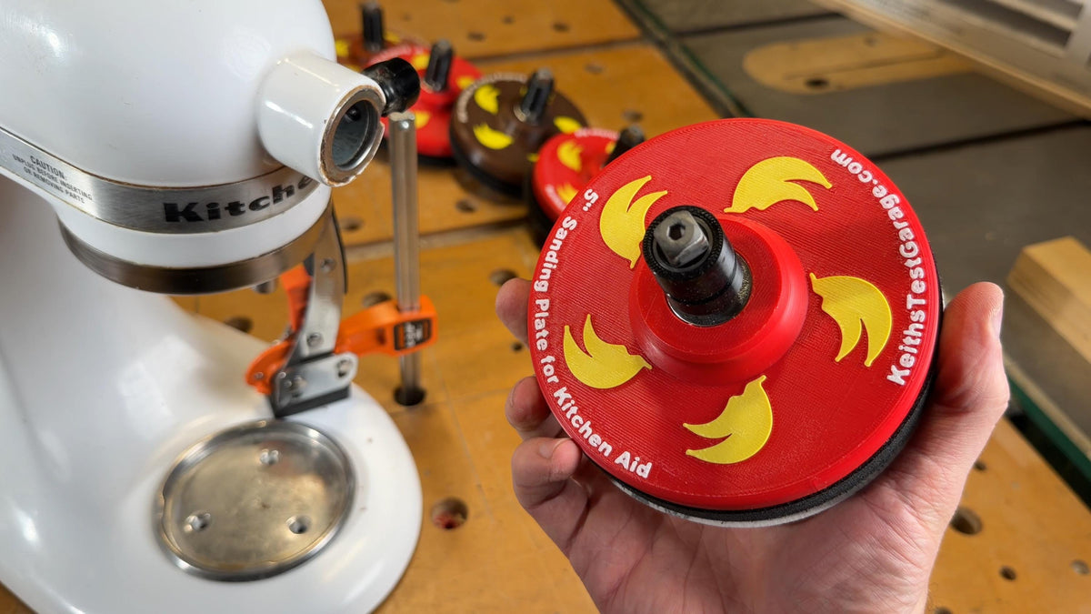 Sanding plate held in hand showing the square drive shaft and TPU bearing sleeve